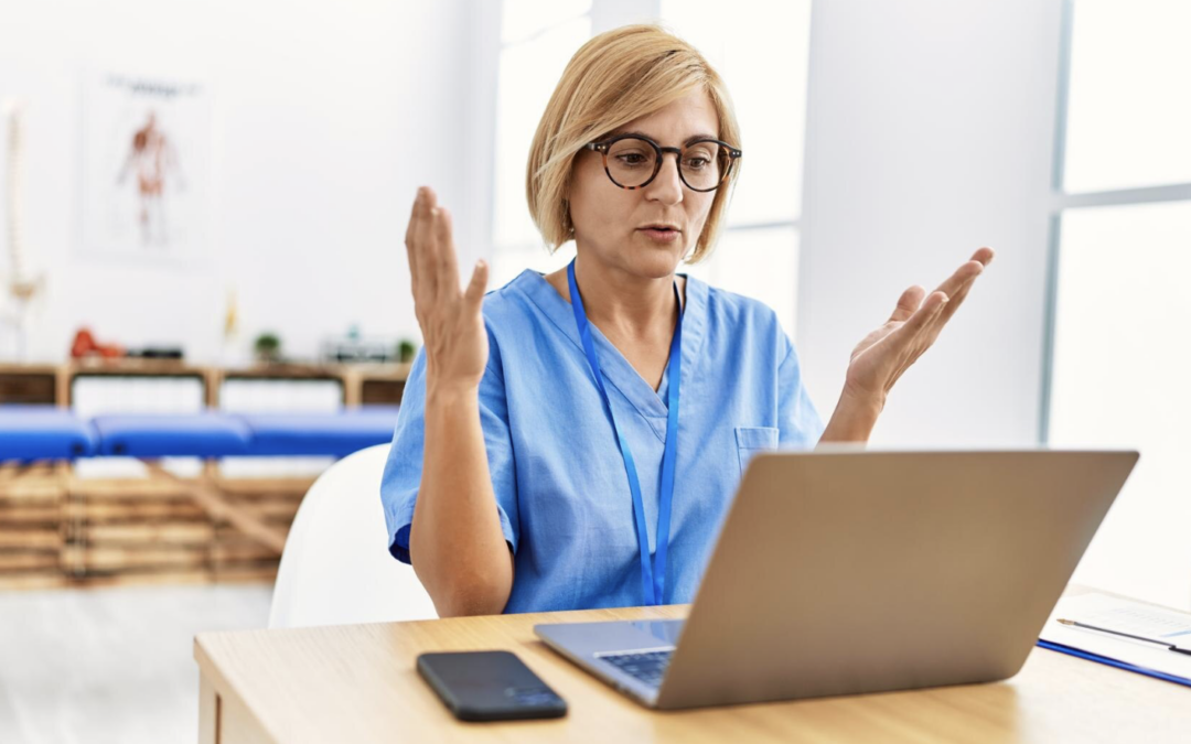 Doctor gesturing at computer after a HIPAA violation